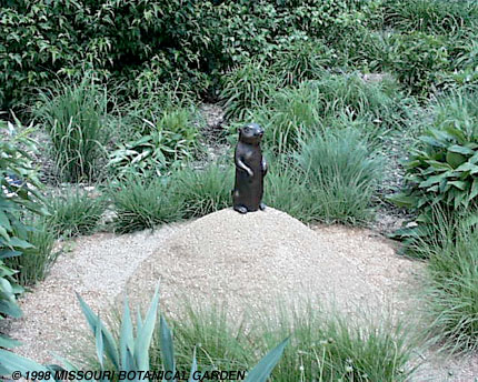 Image of One Prairie Dog, sculpture standing on a sand mound in the prairie