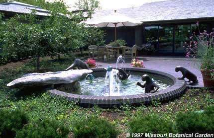Image of Four Playful Otters with Fish fountain