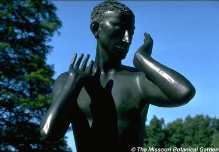 Photographic close-up fo the male Orpheus figure againt a blue sky