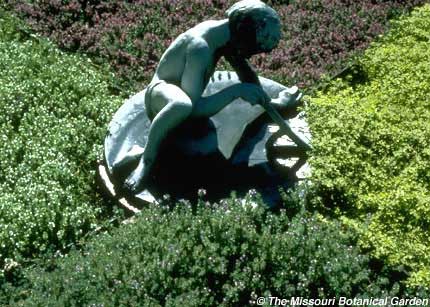 Photograph of 'Child Sundial' with blooming herbs